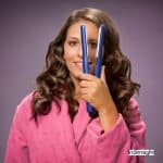 lady holding a flat iron but Can you use a flat iron to curl your hair ?